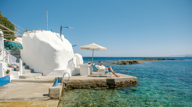 Relaxing by the turquoise waters of Mandrakia, Milos, Greece
