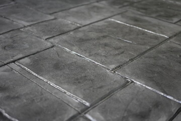 Fototapeta premium The concrete floor features beautiful patterns and intricate textures, distinguished by elegant geometric details and exquisite craftsmanship, creating a unique and visually appealing surface.
