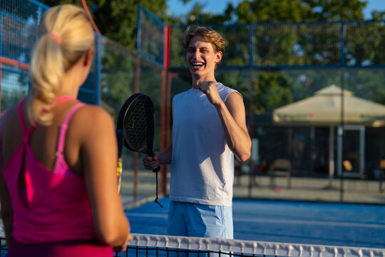 Young man celebrating victory during padel game