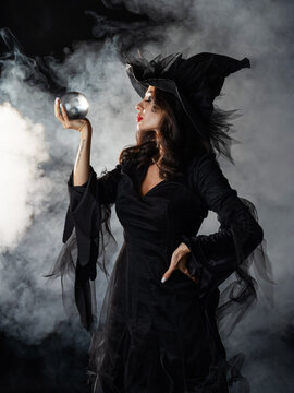 Beautiful witch in black Halloween hat