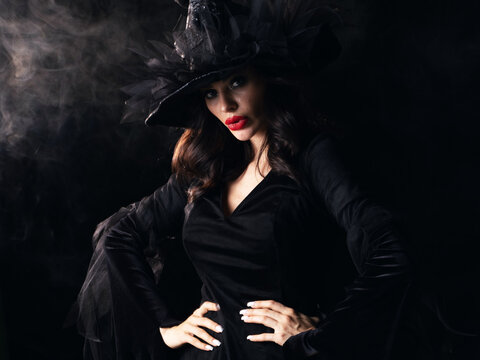 Beautiful witch in black Halloween hat