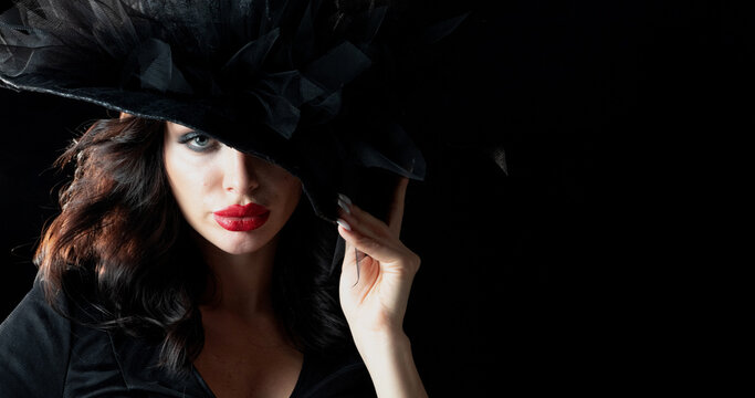 Beautiful witch in black Halloween hat