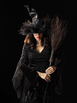 Beautiful witch in black Halloween hat