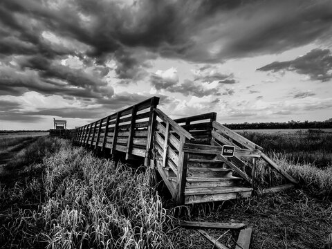 Closed Birdwalk on Upper Myakka Lalke damaged by hurricane  Ian in 2022  on a dark stormy day in Myakka River State Park in Sarasota Florida USA