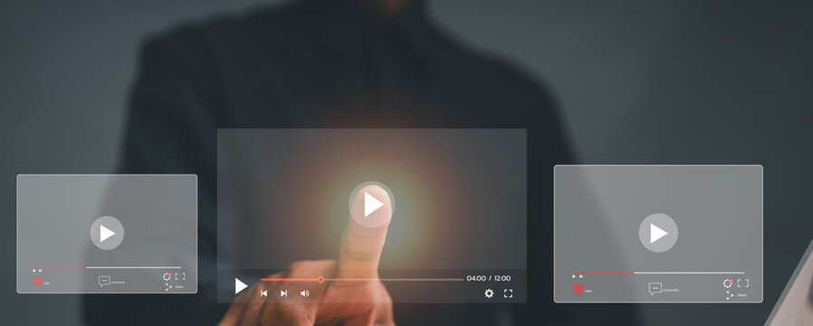 Hand taps a glowing play button on a digital screen. Finger gestures suggest control over media or video content. Fingers hover above interfaces, ready to begin playback