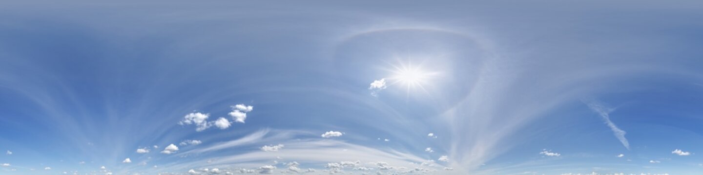 360 hdri blue sky with beautiful clouds with halo like a seamless panorama view with zenith for use in 3d graphics or game development as sky dome or edit drone shot
