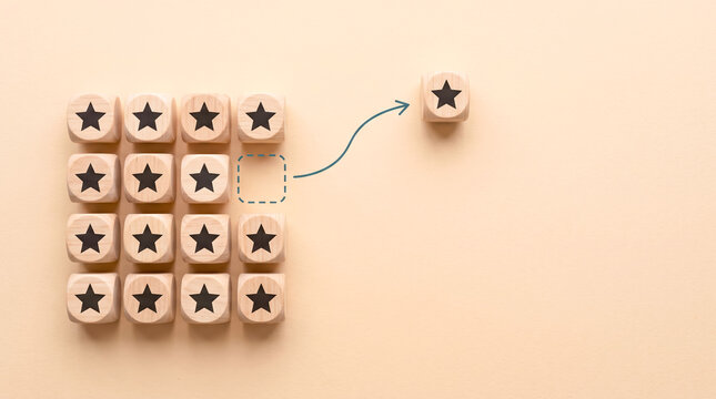 Isolated wooden dice blocks with stars highlighting progress and achievement in business strategy