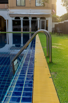 Ladder stainless handrails for descent into swimming pool.