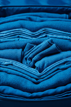 Folded blue clothing in a suitcase