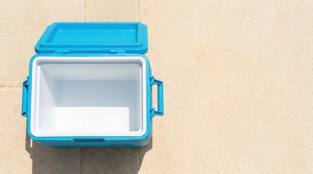 Keeping drinks cold on a hot day with an open empty blue cooler box, ready for beach, picnic, or travel