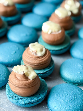 Close-up of blue macarons filled with chocolate ganache and cream filling