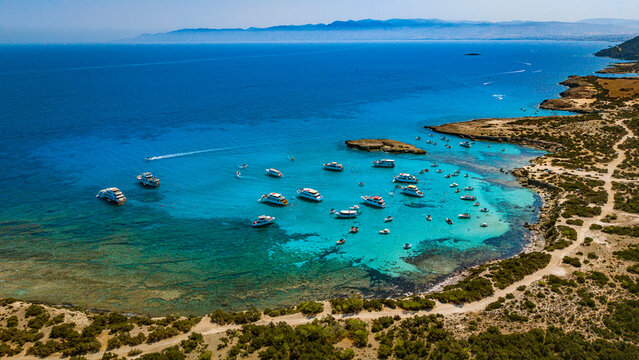 Panoramic aerial landscape of yachts anchored in the vivid waters of Blue Lagoon.