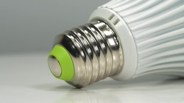 LED lamp with E27 base on grey background, close-up shot video