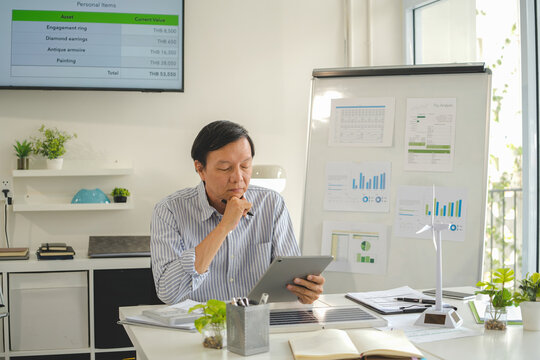 A diverse group of business professionals working together in a modern office, analyzing environmental data and charts to develop eco-friendly, sustainable corporate strategies.
