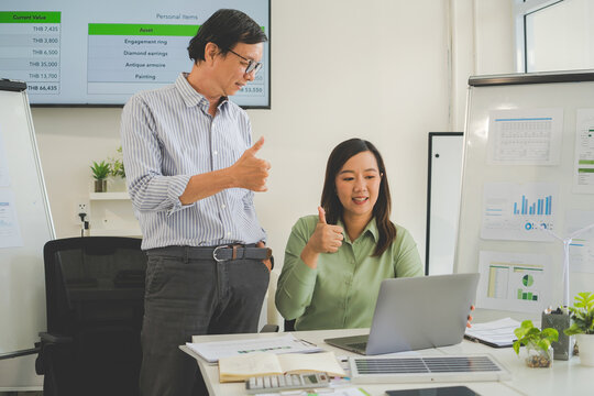 A diverse group of business professionals working together in a modern office, analyzing environmental data and charts to develop eco-friendly, sustainable corporate strategies.
