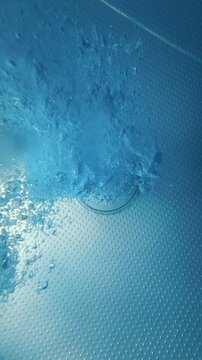 Pool jets releasing air bubbles along textured pool floor underwater