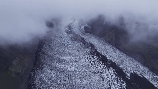 Aerial view of Jokulsarlon glacier with deep crevasses and surrounding mist in the highlands, Sveitarfelagid Hornafjordur, Iceland.