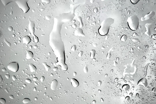 Clear water drops, water texture and condensation on smooth glass texture background