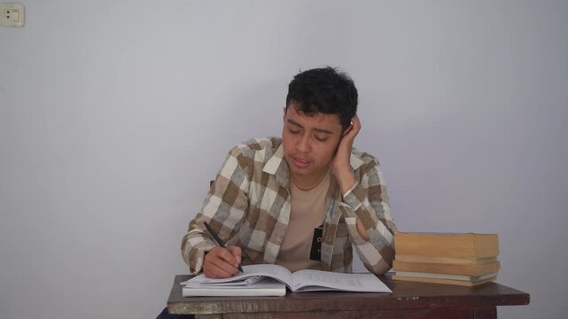 A Young Man Struggling with Thoughts While Studying, Expressing Frustration and Distraction