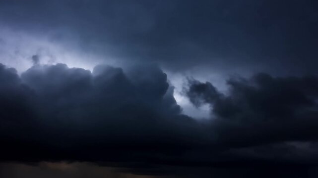 Dark storm clouds rolling across the dramatic sky with heavy rain falling