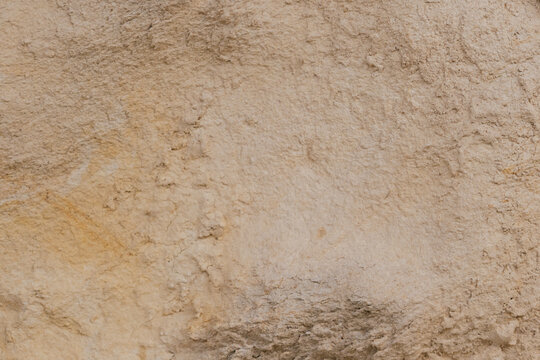 Beige sandstone rock surface macro texture with rough natural stone structure for architectural background copy space stock photo