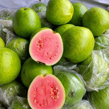 Fresh Green Guavas with Pink Flesh Cut Open for Display