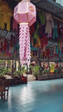 Colorful hanging lanterns decoration at Thai Wat Lok Moli in Asia, Traditional festive lanterns at Buddhist temple with cultural design and pattern, Chiang Mai, Thailand, 4k vertical video