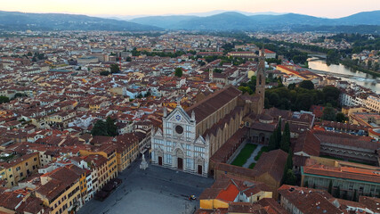 Fototapeta premium Basilica Santa Croce square Florence high aerial drone view Italy Tuscany cityscape Arno river travel vacation background commercial stock photo horizontal