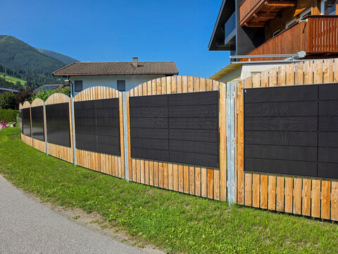 Wooden fence with solar panels