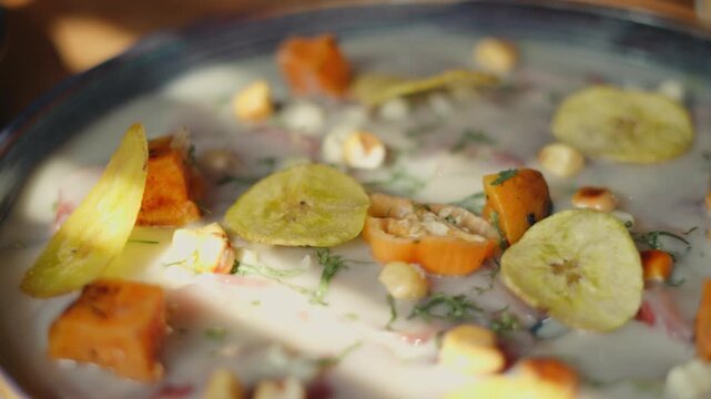 Delicious peruvian ceviche with fresh fish, sweet potato, banana chips, and cancha corn
