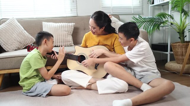 Mother and children using tablet together at home