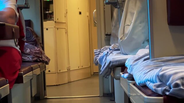An empty passenger train carriage corridor with sleeping berths and beds, travel agency, tourism industry, vacation journey, railway transportation.
