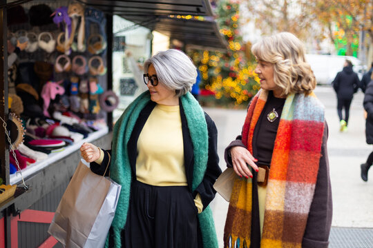 Senior women shopping at seasonal market stall