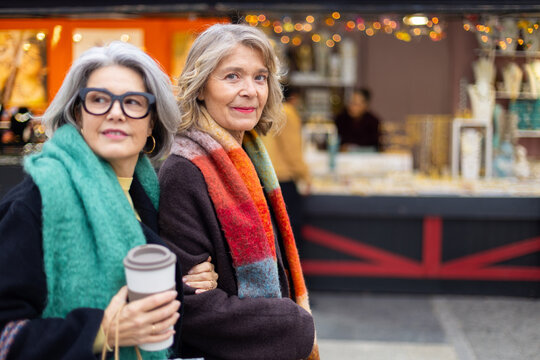 Senior women friends enjoying city shopping experience