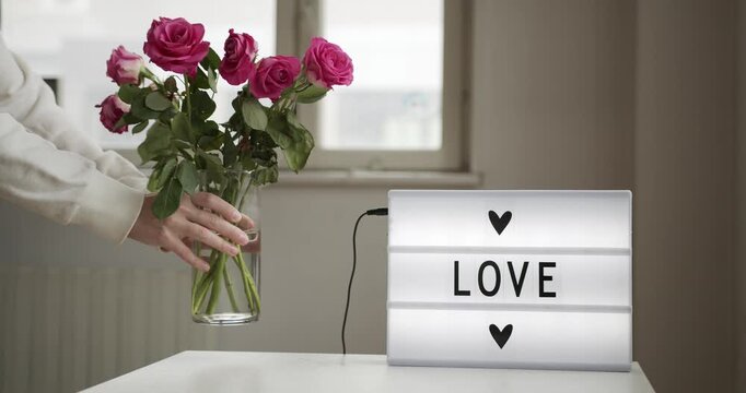 Led cinema light box displaying the word love with heart symbols on white table lightbox sign message romance romantic