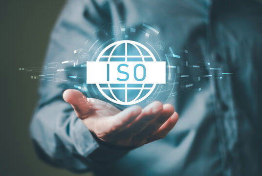 ISO, Quality standards and compliance concept, quality management, business assurance and operational control. Featuring a professional hand presenting a globe with certification symbols.