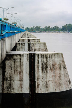 Concrete Pillars and Bridge Structure Over River Side View