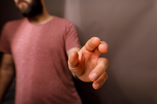 Close-up of a man's hand extending, touching, or pointing. Symbolic of connection and int