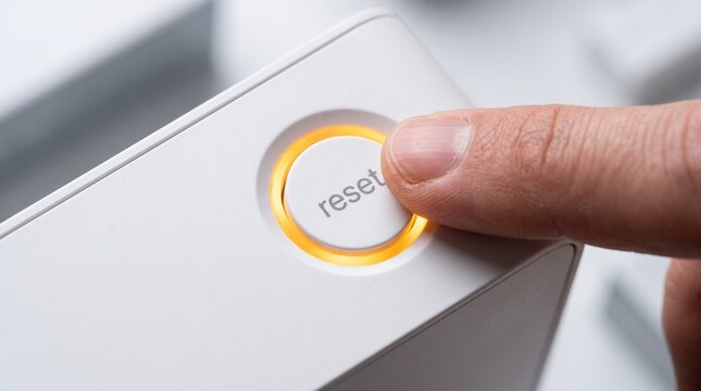 Hand pressing reset button on device panel
