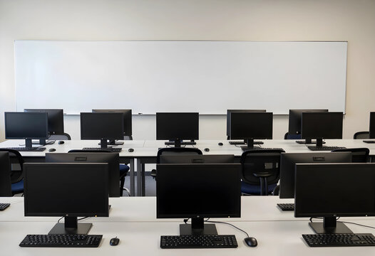 Empty computer lab classroom with multiple desktop monitors and keyboards on white desks education and technology-focused