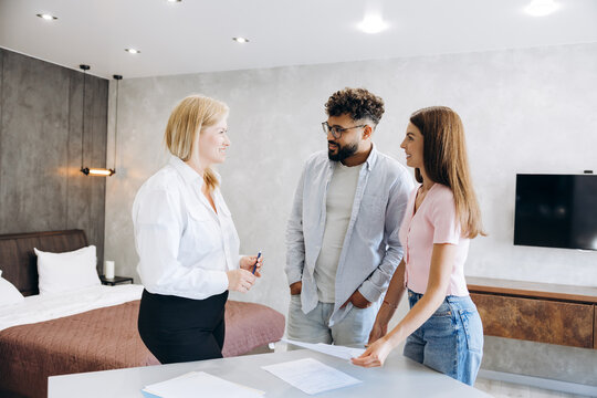 Real estate agent discussing property purchase with young couple