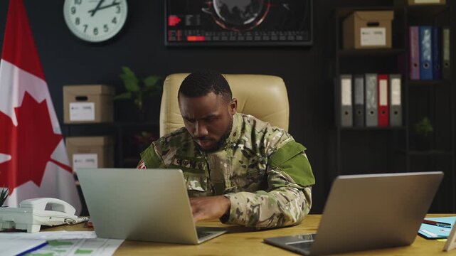 African Canadian soldier plans military operation, collecting satellite data