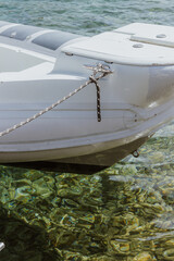 Inflatable boat moored in crystal clear Adriatic water in Kornati, Croatia. Scenic Mediterranean sailing destination with rugged islands, sunlight reflections and peaceful summer atmosphere. © Ivanka