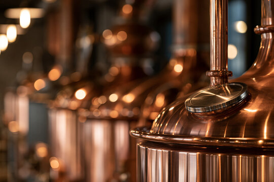 Shiny copper tanks in a modern distillery. Industrial production.