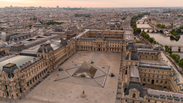 PARIS, FRANCE - JUNE 15, 2025: Aerial perspective of Louvre glass pyramid and historic courtyard