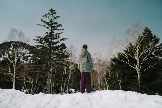 Girl looking at snowy forest.