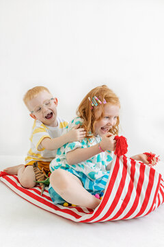 Children play together on a colorful mattress