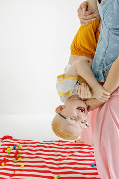 Child plays hanging upside down