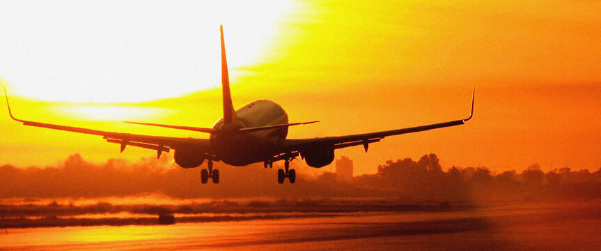 Airplane landing silhouette against blazing heatwave sunset sky