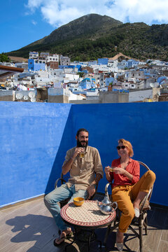 Tourists Drinking Mint Tea on a Rooftop Terrace in Chefchaouen